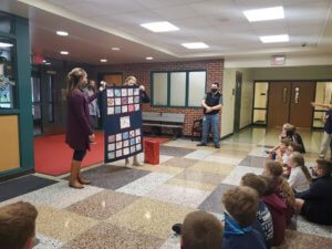 3rd graders delivering quilt to Principal Gillon